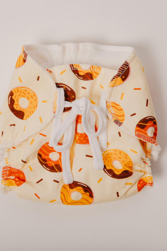 Close-up of Airy Cotton Nappy showing breathable, soft cotton material and gentle elastics. A reusable, eco-friendly solution for mess-free diaper-free time. Protects delicate baby skin while preventing leaks and rashes.