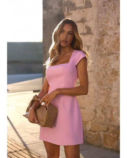 Light pink hourglass mini dress with clean square neckline, worn outdoors with nude clutch. A fresh, elegant choice for spring weddings, prom 2025, or graduation celebrations. Tailored fit with timeless appeal. Made in Europe for fashion-forward women who love minimalist chic.