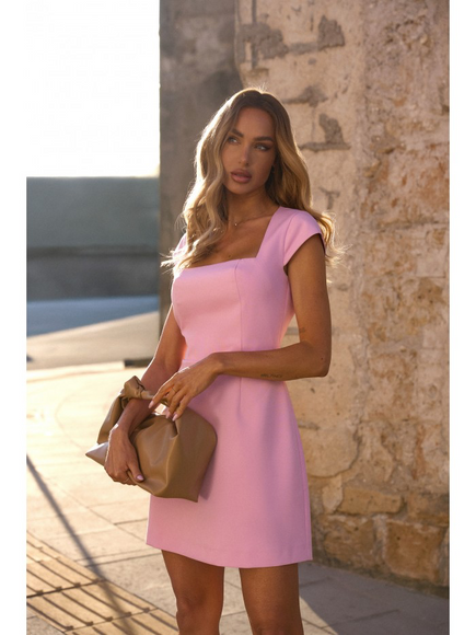 Light pink hourglass mini dress with clean square neckline, worn outdoors with nude clutch. A fresh, elegant choice for spring weddings, prom 2025, or graduation celebrations. Tailored fit with timeless appeal. Made in Europe for fashion-forward women who love minimalist chic.