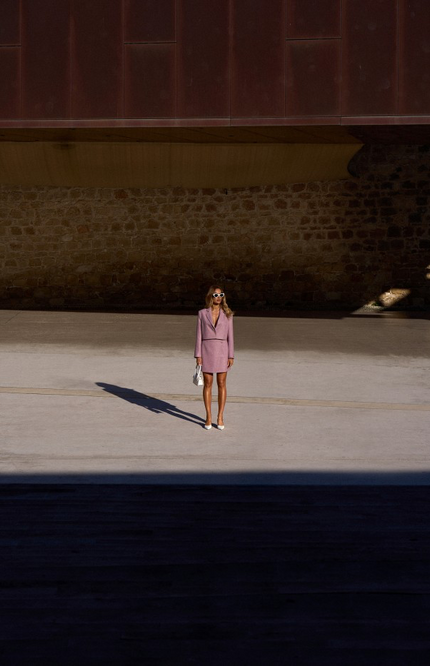 Front view of a pink high-waisted skirt with subtle texture and a clean zipper closure.