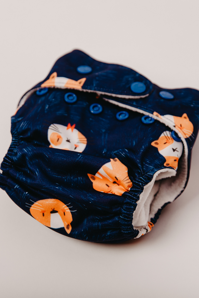 EcoNappy Cloth Diaper made with organic cotton and an absorbent insert pad, offering superior leakage protection. Perfect for naps, outings, and nighttime use. Eco-friendly, reusable, and designed for long-lasting comfort.