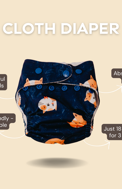 Navy blue cloth diaper with animal print and labels highlighting its features: absorbs 4–5 pees, no harmful chemicals, and eco-friendly material.