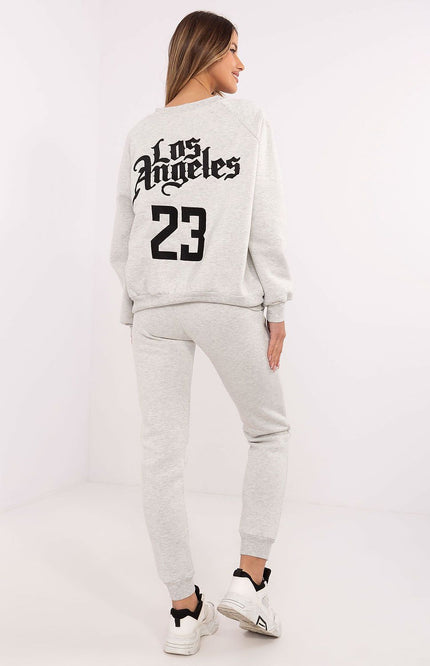 Back view of light grey tracksuit featuring “Los Angeles” embroidery and high-waisted joggers