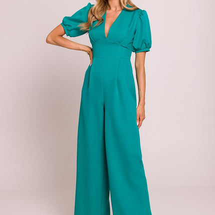 Moe Woman wearing a teal wide-leg jumpsuit with short sleeves and a deep v-neckline, perfect for formal occasions.